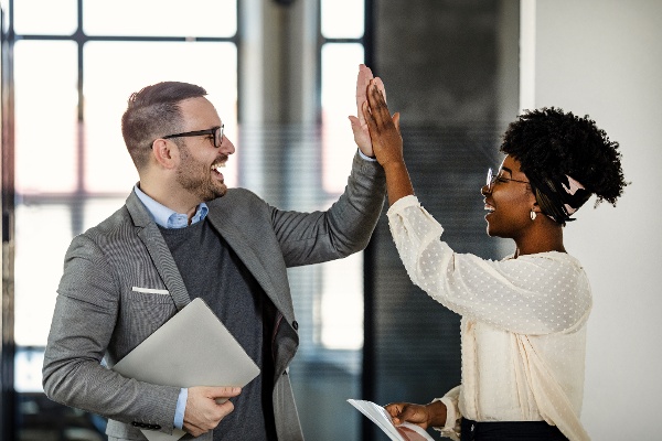 A man and woman high fiving