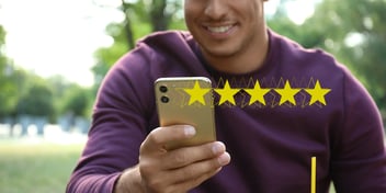 A man smiling at his phone with yellow stars superimposed over